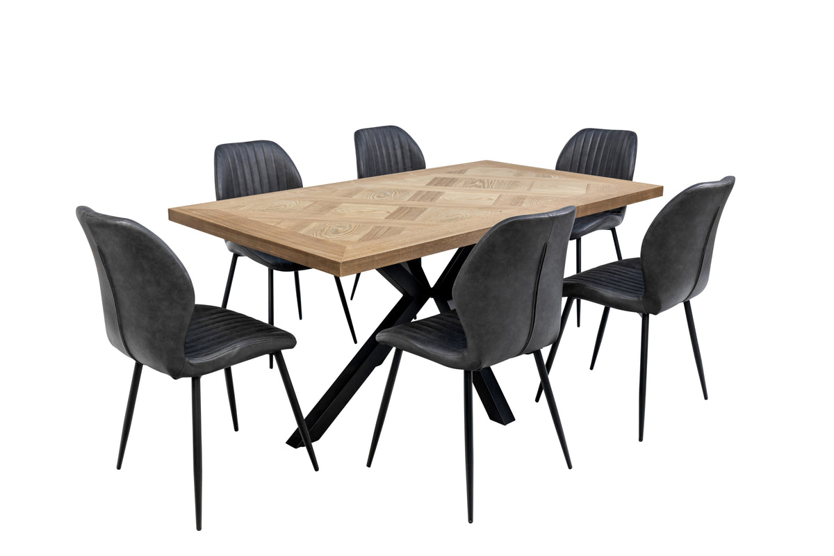Charcoal faux leather dining chairs with ribbed back and black metal legs