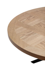 Round oak veneer tabletop close-up with light wood parquet pattern