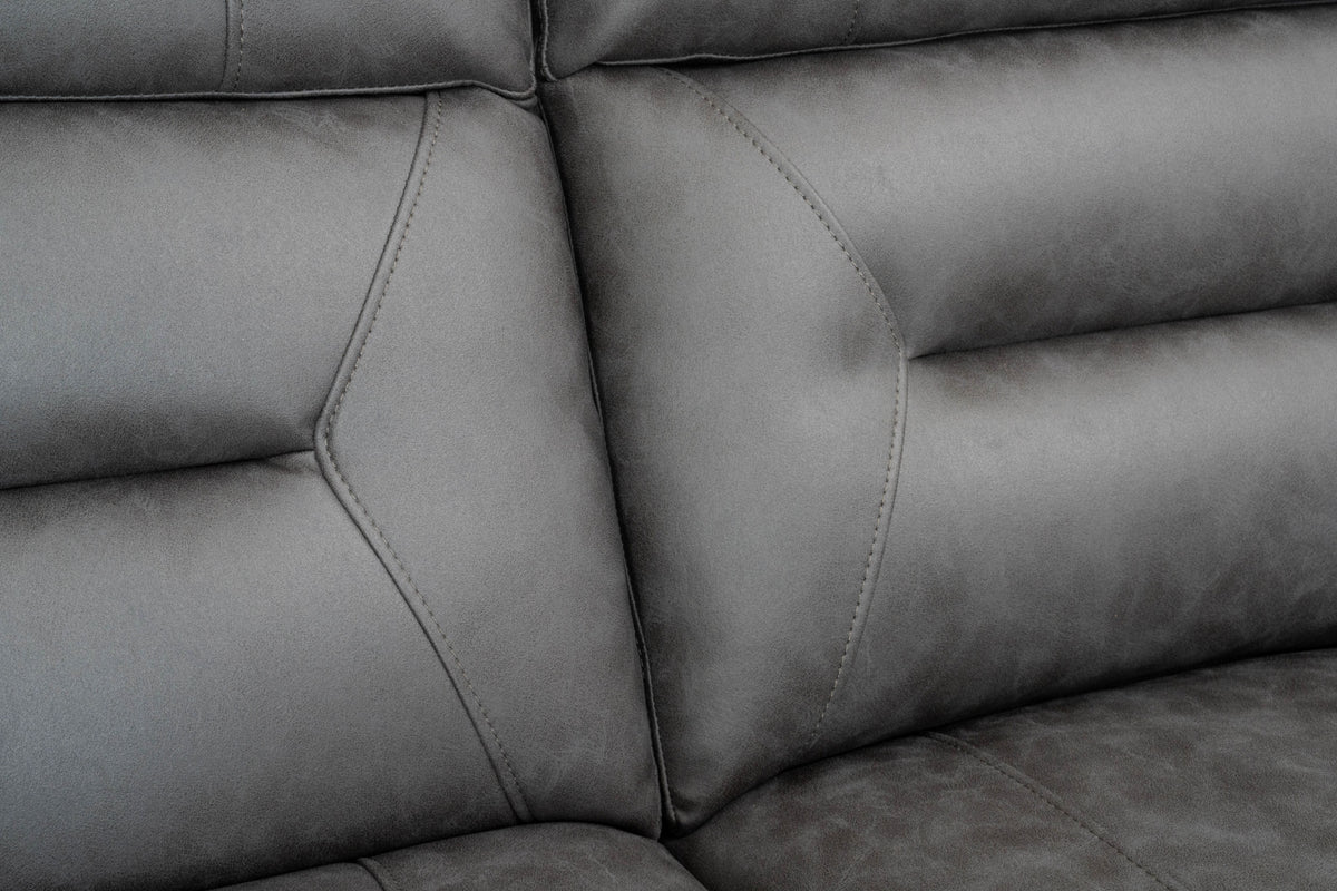 Grey sectional side panel with curved arm and stitched cushion edges