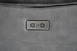 Grey recliner sofa power control panel on upholstered armrest