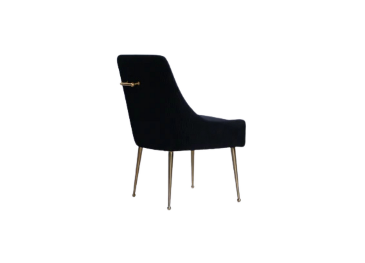 Black upholstered accent chair angled view with brass bar detail and slim metal legs
