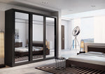 Sliding door wardrobe with dark frames and mirrored doors in a bedroom setting