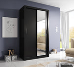 Black sliding door wardrobe with two metal handles and vertical glass-panel doors