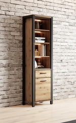Slim display cabinet, open door with lit interior shelves and two storage drawers