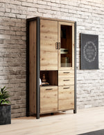 Double display cabinet with light oak doors, dark frame, shelves and drawers
