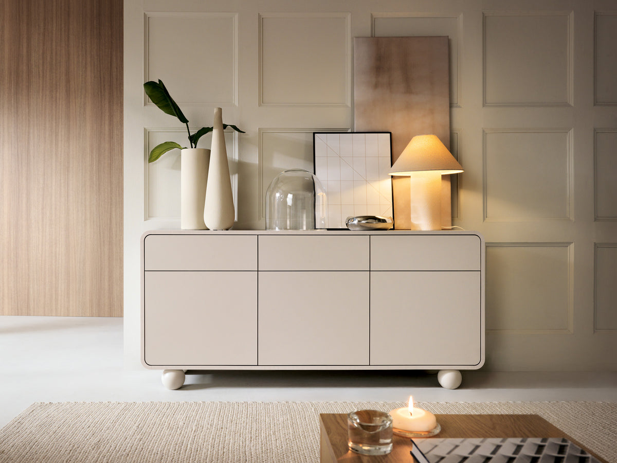 Beige sideboard with three drawers and three doors, top surface visible