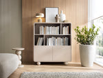 Light beige highboard with open bookshelves, two cabinet doors, rounded corners, legs