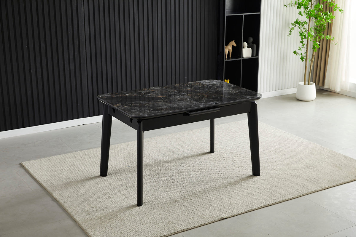 Extendable dining table with dark ceramic tile top and black metal legs