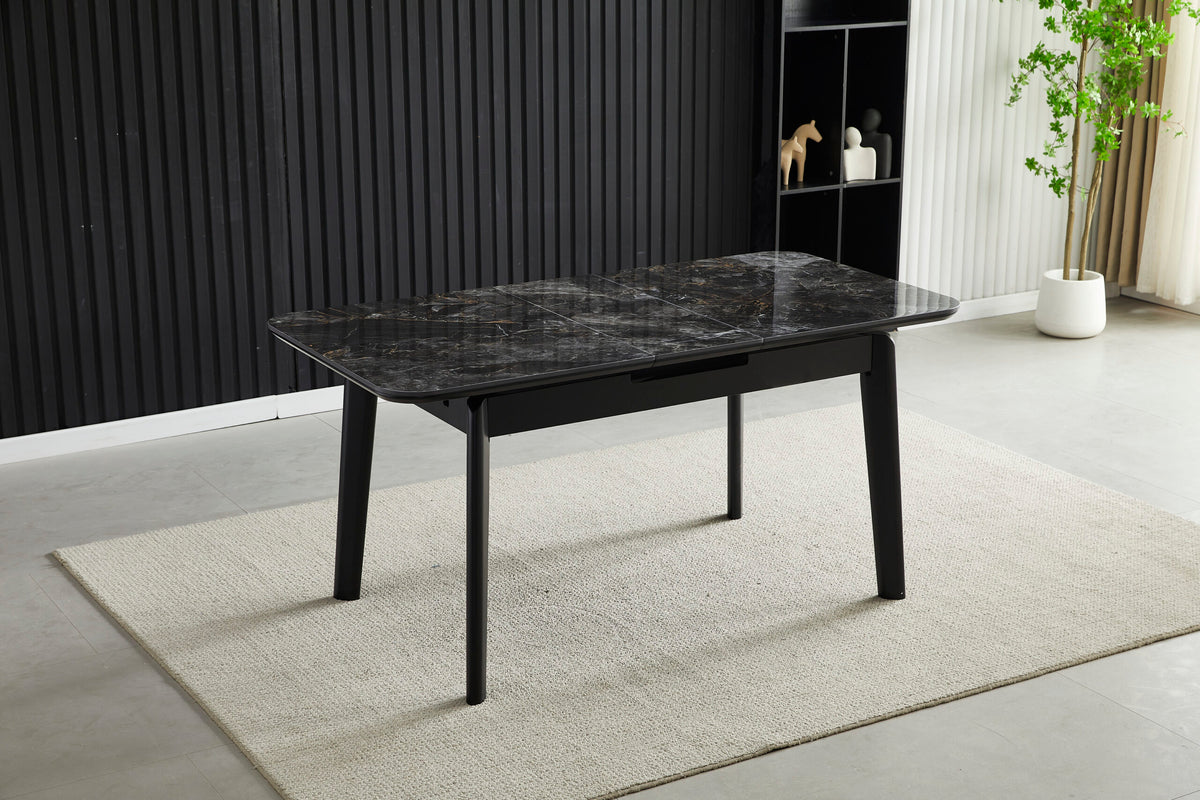 Extendable dining table with dark ceramic tile top and black metal legs