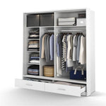 White sliding door wardrobe with hanging clothes, shelves, and two drawers
