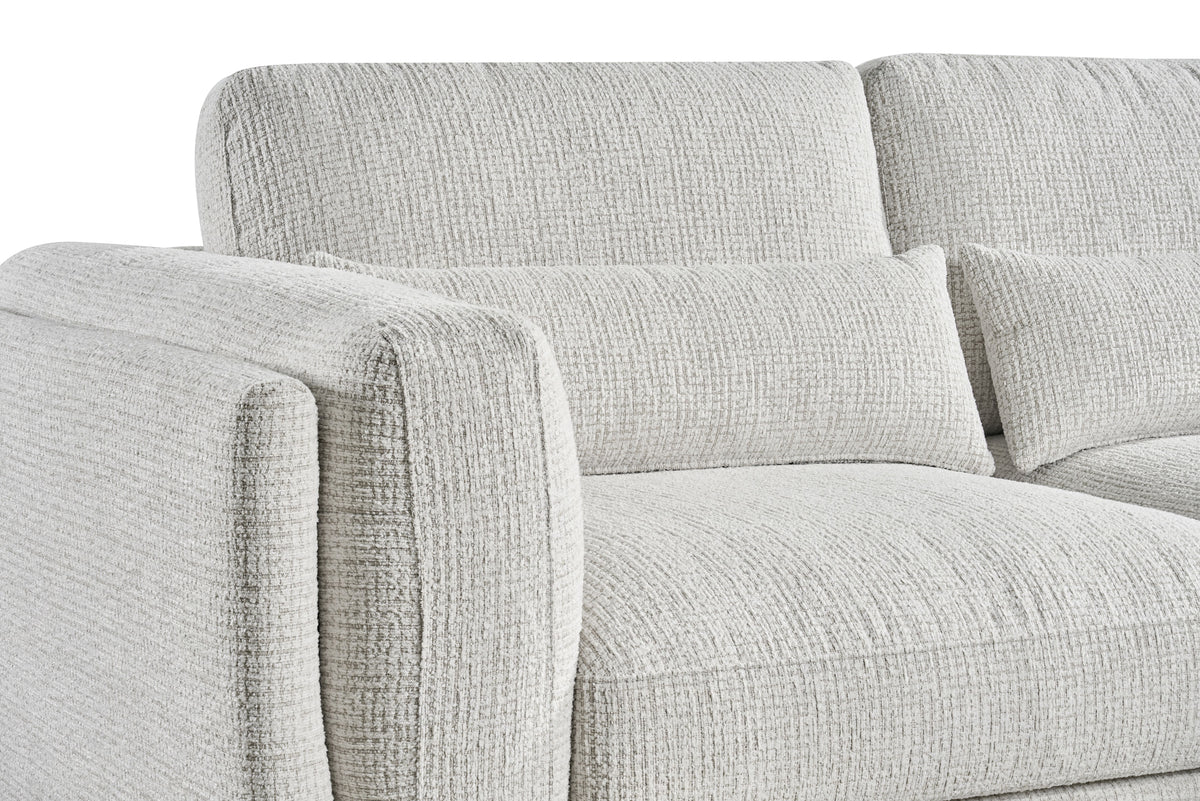 Light grey sofa upholstery close-up with cushioned arms and stacked back cushions