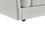 Light gray armchair close-up of skirt base, black legs, and padded arm panels