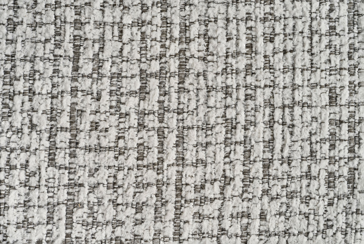 Textured woven upholstery fabric with grey and cream speckled pattern