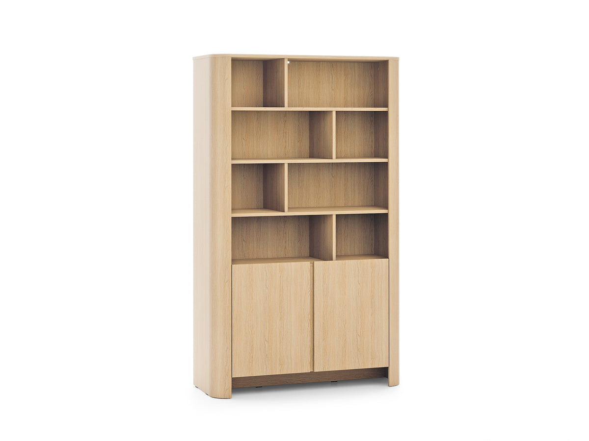 Light oak bookcase with open cubby shelves and two lower cabinet doors.