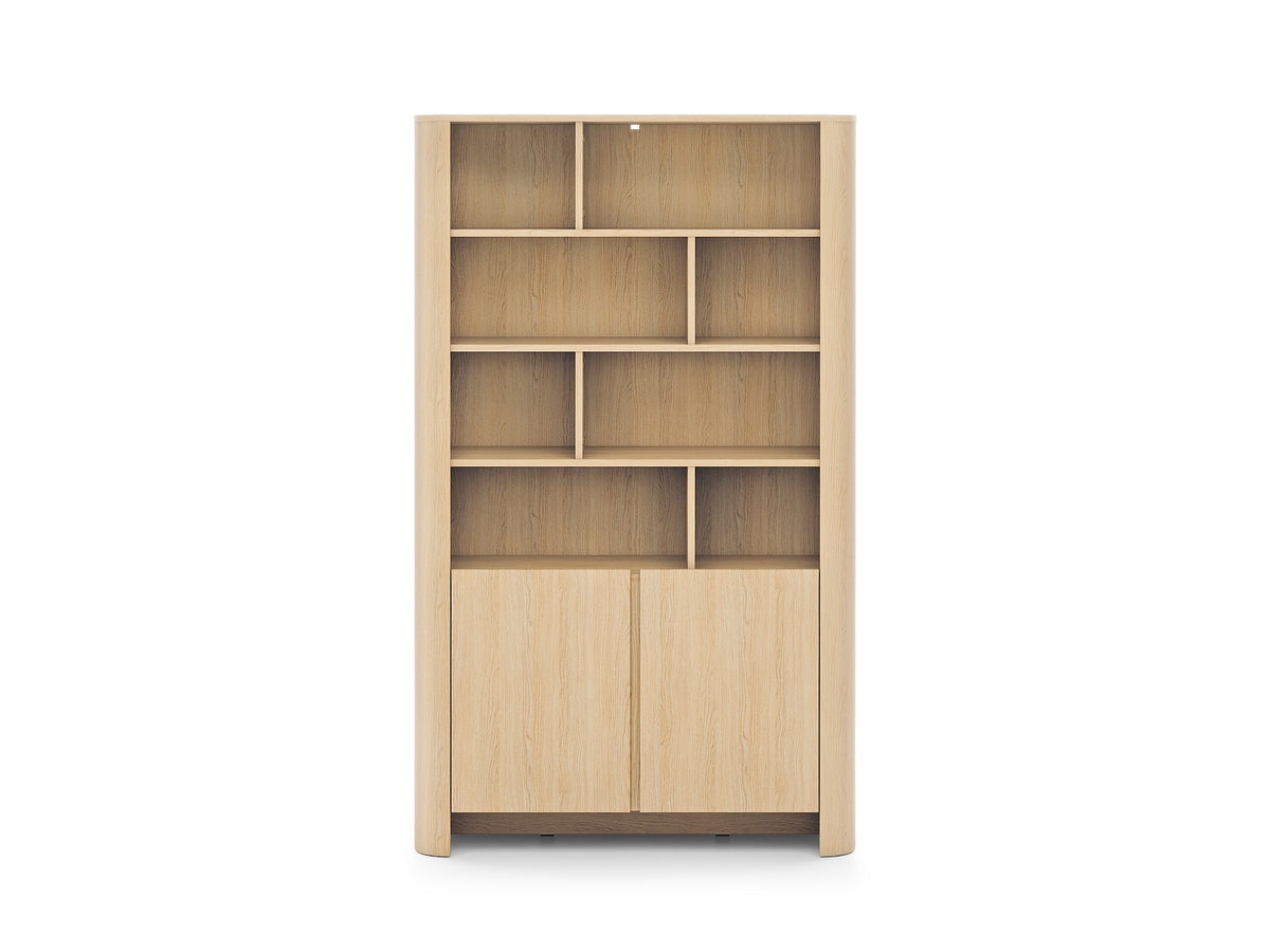 Light oak bookcase front view with cubby shelves and two panel doors.