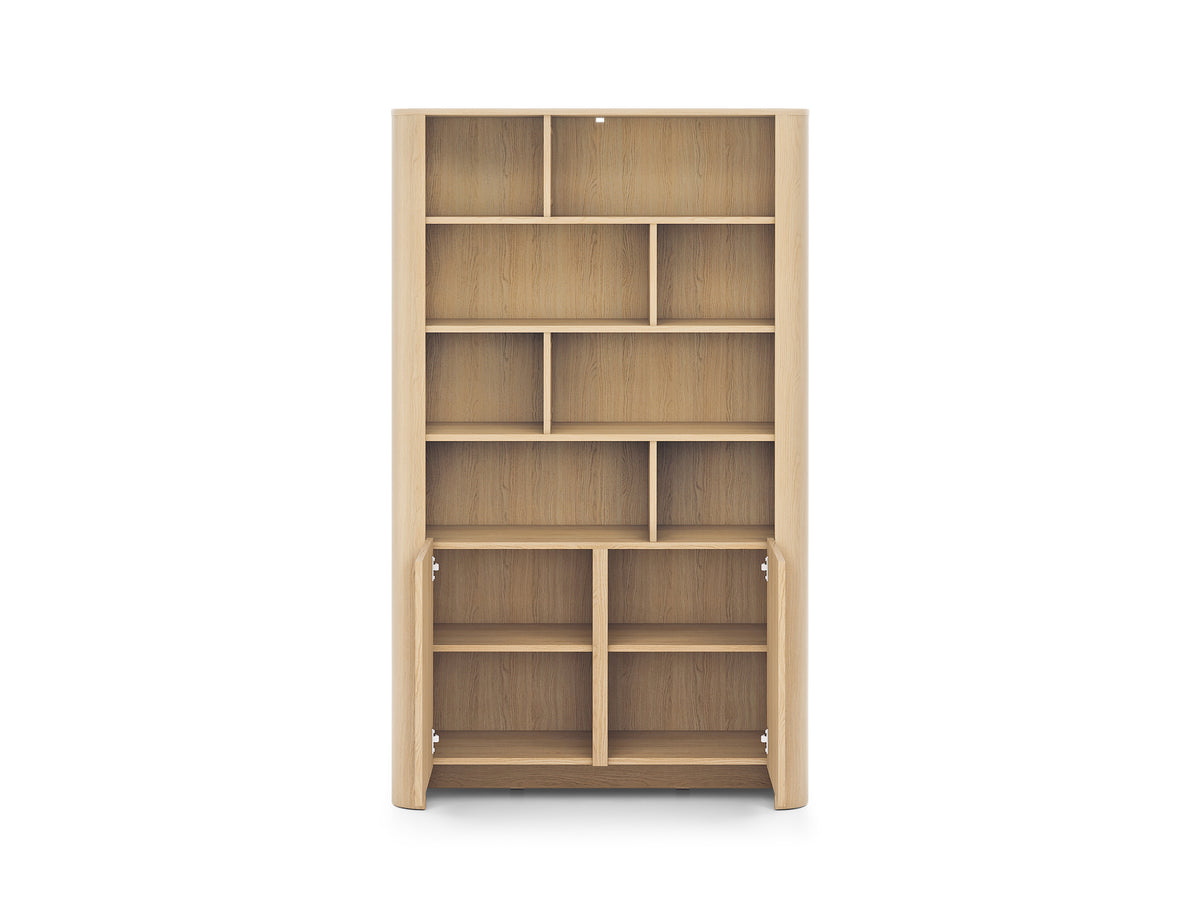 Light oak bookcase with open cubby shelves and lower doors swung open.