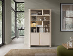 Gray bookcase with open shelving top and two doors at the bottom.