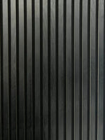Close-up black acoustic wall panel with vertical ribbed slats and narrow gaps