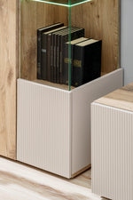 Cabinet base with ribbed fronts and open storage for books