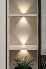 Open media wall cabinet with lit shelves and glass-front compartment