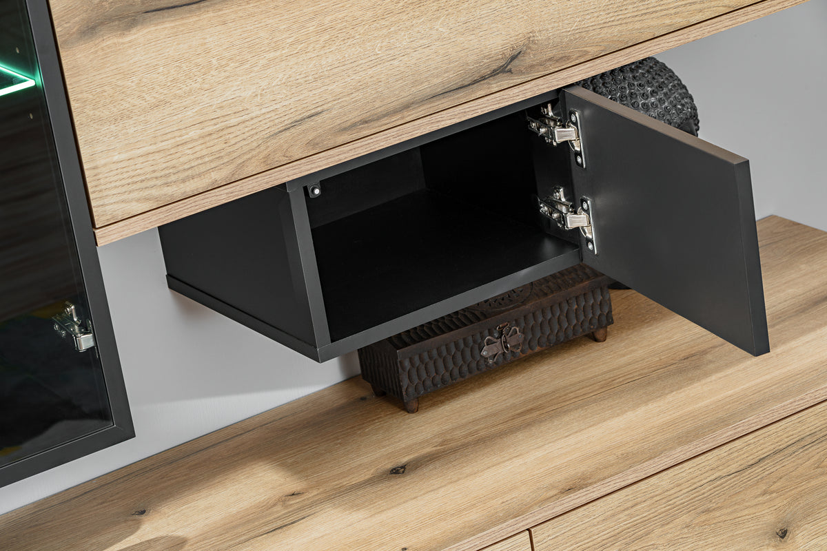 Open flip-door shelf showing interior storage with light wood front and black hinges