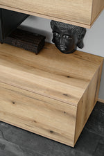 Lower cabinet section with light wood drawers and open shelf for decor items