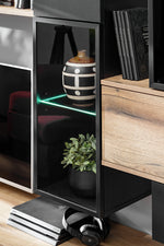 Wall unit with open black shelves, light wood drawer fronts, book storage and decor space