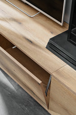 Drawer rail and sliding track detail on light wood wall unit with black side frame