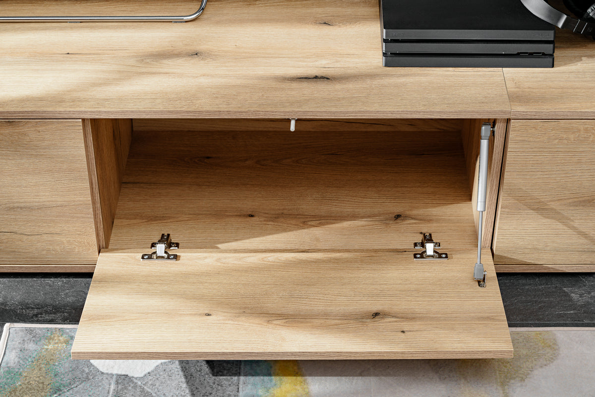 Open tabletop compartment inside wall unit with light wood interior and metal brackets