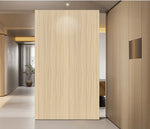 Light wood wall panel board with vertical grain, shown standing on wall