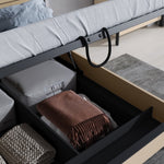Ottoman bed open storage compartment with folded blankets and lift mechanism