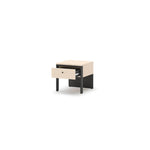 Beige and black bedside table with drawer, open base, and black tapered legs.