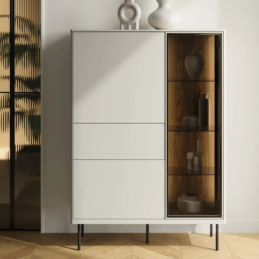 White sideboard-style cabinet with tall glass door showing dark wood interior shelves.