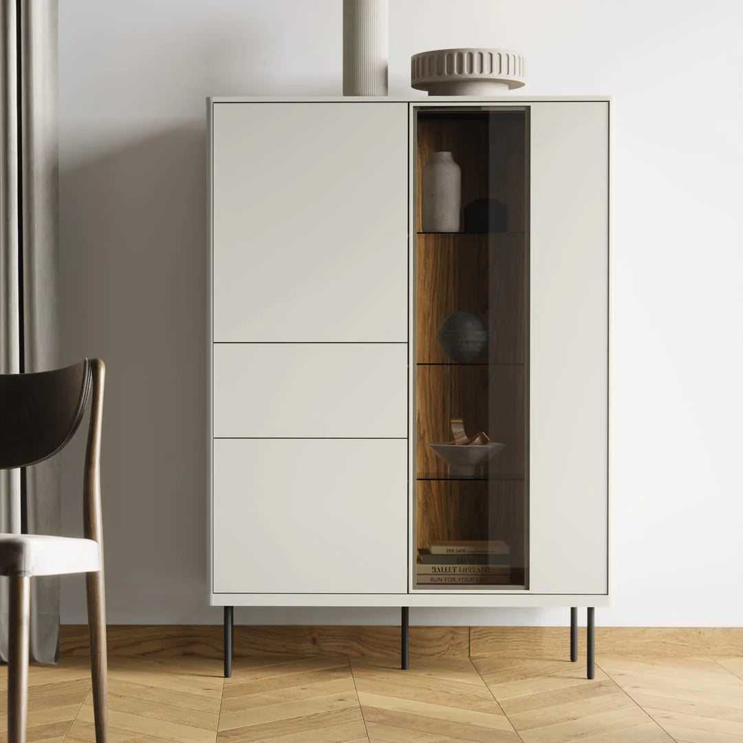 Light grey cabinet front with partial glass door showing shelves and decor inside