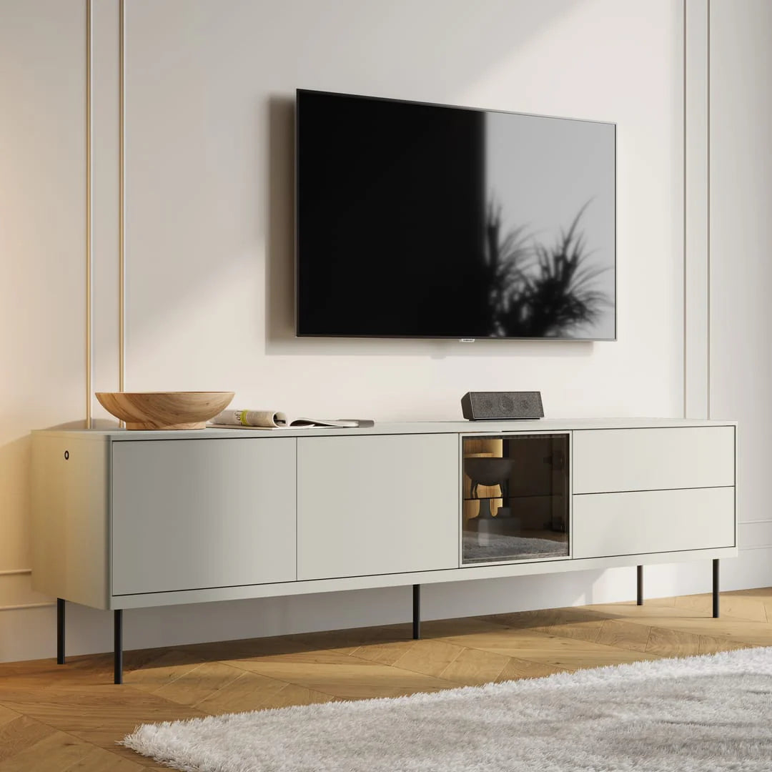 Low TV cabinet with glass-front center compartment and two side drawers, light gray
