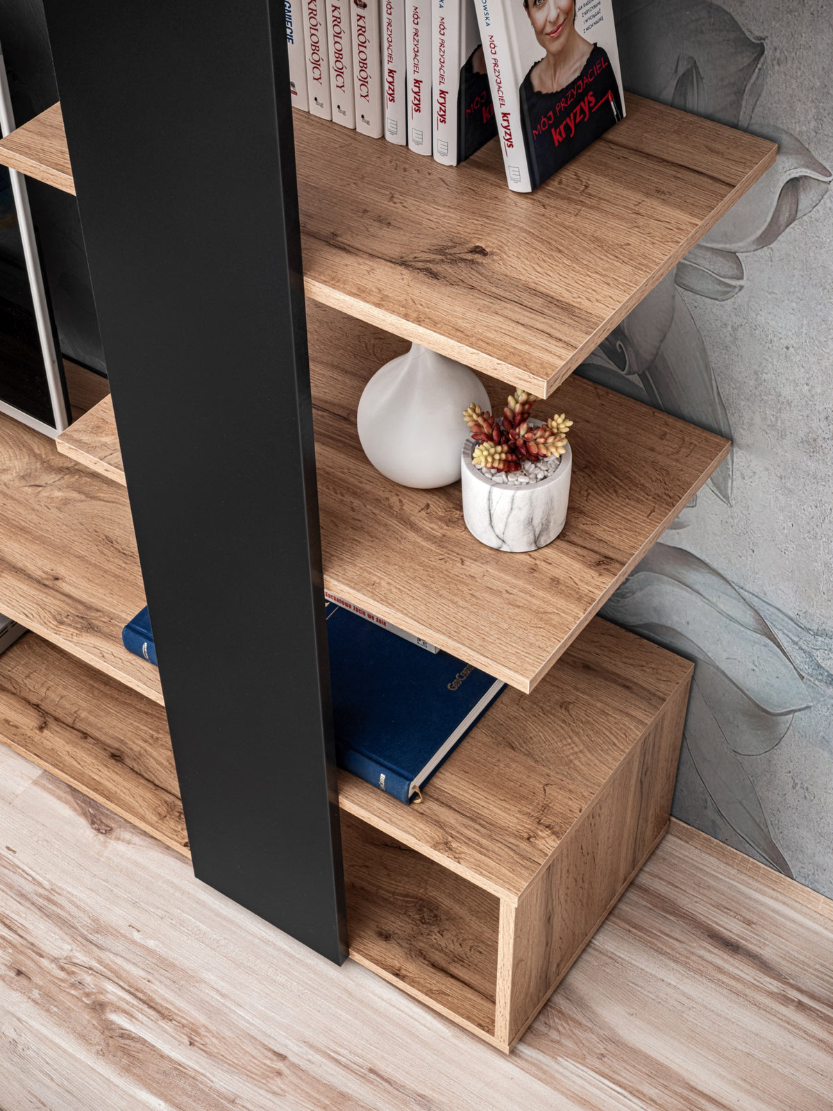 Black media wall cabinet with open shelves and light-wood steps for storage