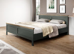 Dark teal bed with two pillows, light duvet, and front drawer base