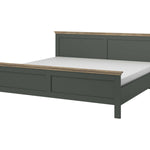 Dark teal bed frame side view with paneled headboard and low footboard