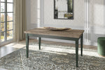 Extendable dining table with rustic wood top and dark green legs.