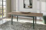 Extendable dining table with rustic wood top and dark green legs, three-quarter view.