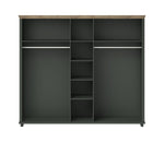 Dark green wardrobe interior with multiple shelves and central cubby compartments