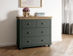 Small chest of drawers in dark green with wooden top and four drawer fronts