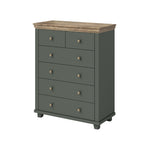 Dark green chest of drawers with light wood top, four drawers and round metal knobs.