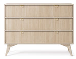 Light wood chest of drawers with three drawers and gold triangular handles, tapered legs
