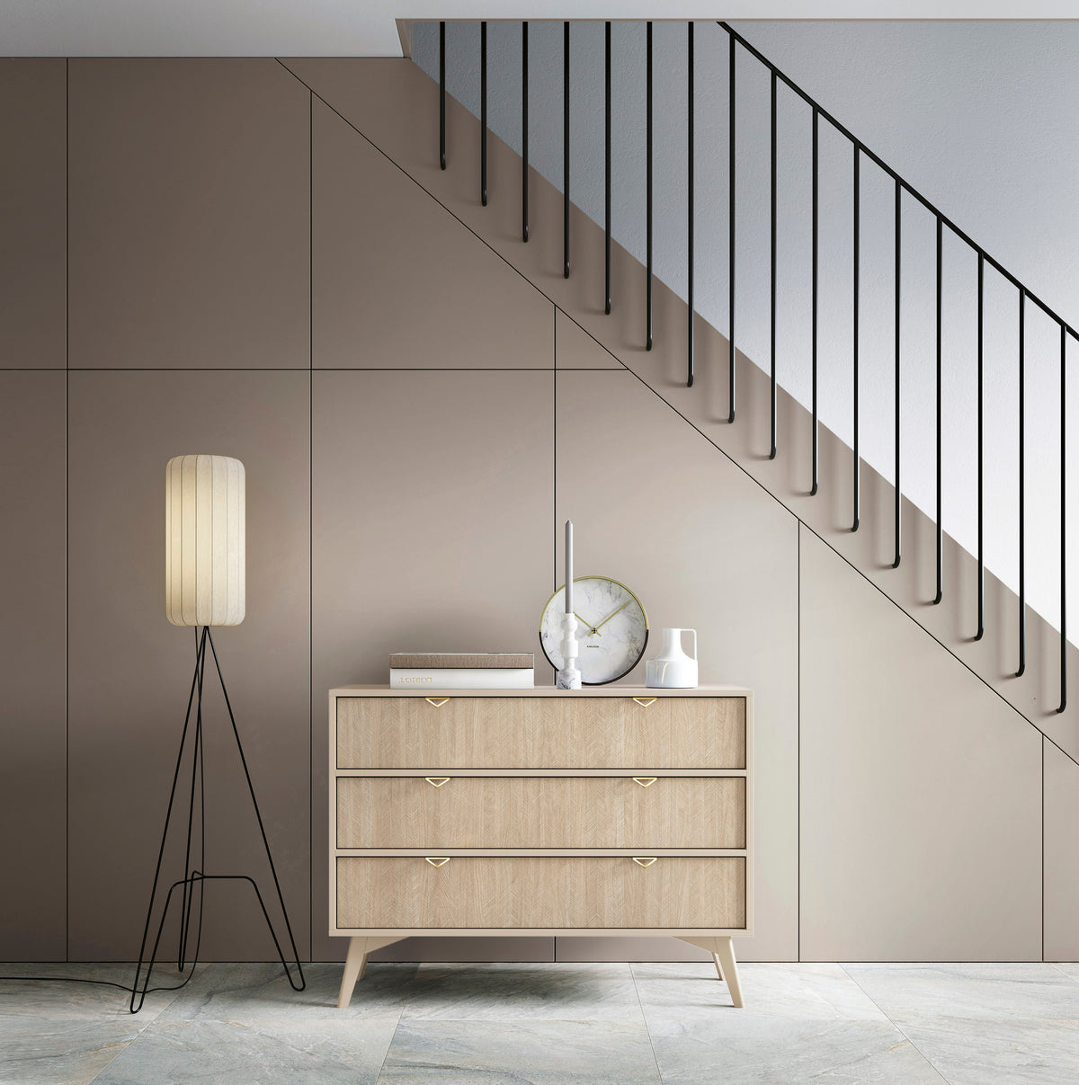 Three-drawer light wood chest with gold triangular handles and slim tapered legs