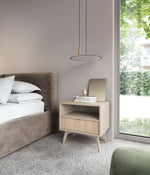 Olive green bedside table with open shelf and drawer, styled in a bedroom setting.