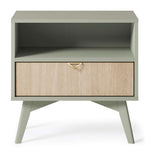 Olive green bedside table with open shelf and herringbone drawer front panel.