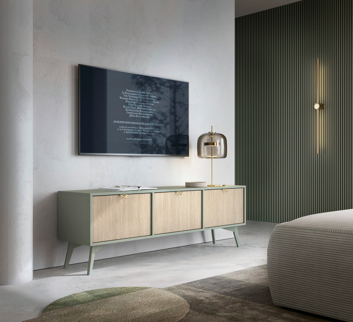 Olive green TV cabinet with three wood doors and brass pulls