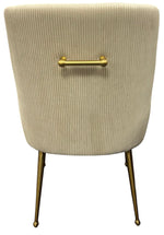 Cream ribbed upholstered accent chair back with brass bar detail and slim metal legs