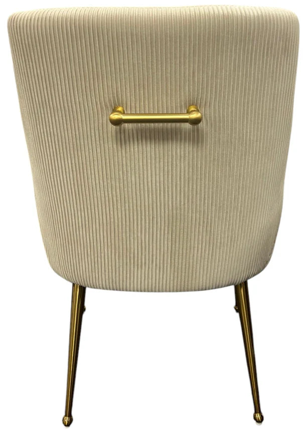 Cream ribbed upholstered accent chair back with brass bar detail and slim metal legs
